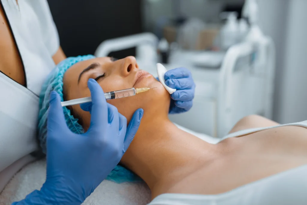 cosmetician gives chin botox injection to patient