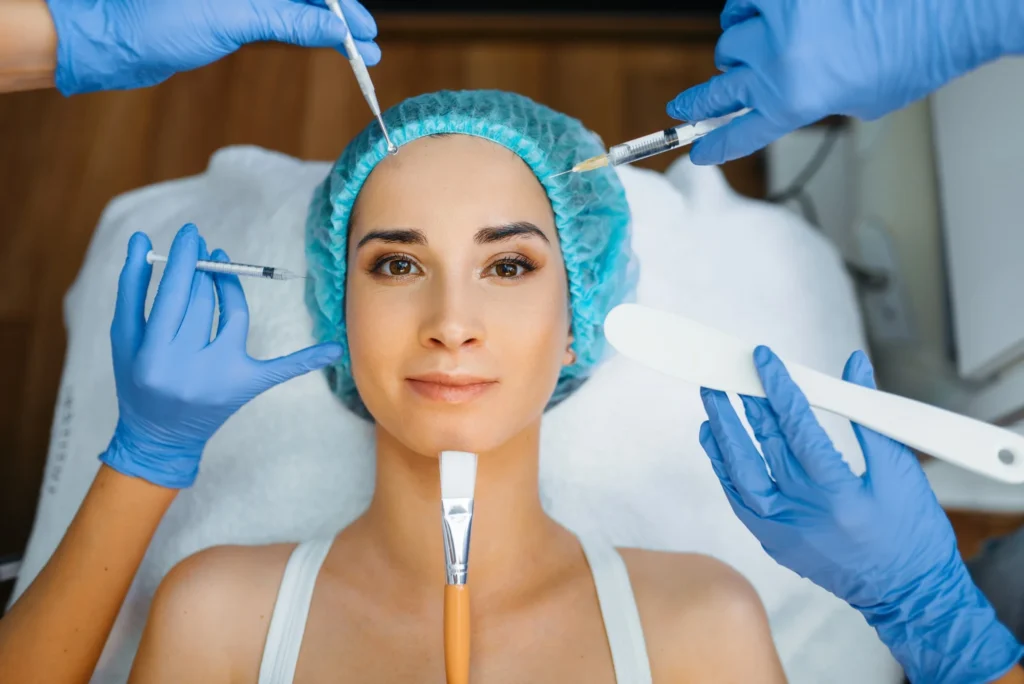 cosmetician hands with working tools patient face